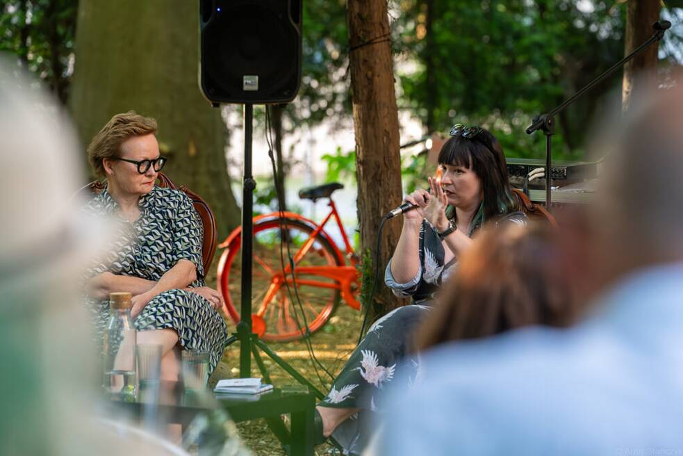 Two female speakers and a bike