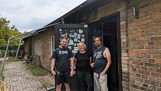 Lars, Paula und Marshall vor der Ausstellungsbaracke