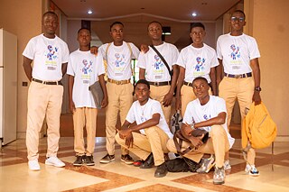 A gruop of Kouman Workshop participants wearing Kouman branded T-shirts