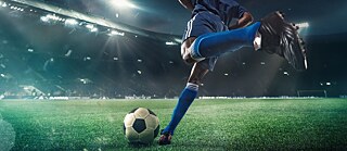 a soccer player kicking a ball