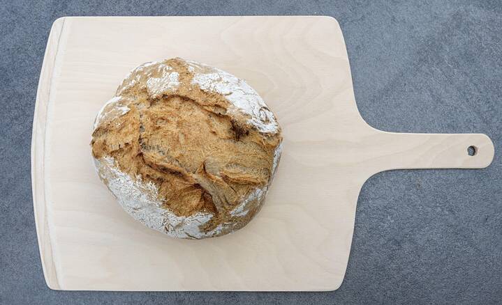A farmer's bread on a wooden board.