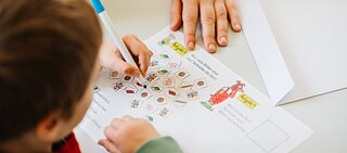 A child taking a school lesson