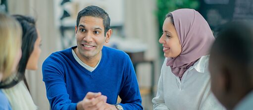 Personen sitzen zusammen und unterhalten sich