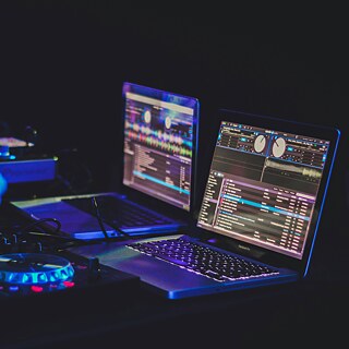 Laptops at a dj's desk