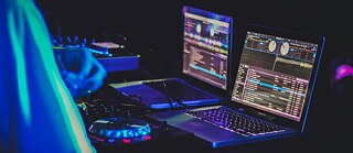 Laptops at a dj's desk
