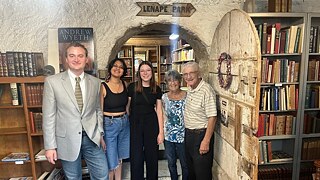 Iven Yorick Fenker and Sonali Beher stand alongside three others in a bookstore.