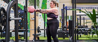 Young woman training with weights at the gym