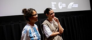 Two girls at an info-stand