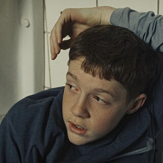 Boy sitting in a toilet