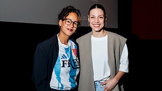 Sarah Blaßkiewitz and Haley Louise Jones standing in front of a movie screen