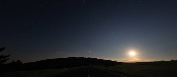 When the moon is shining, its silvery light lies like a veil over the nighttime landscape of hills and meadows.