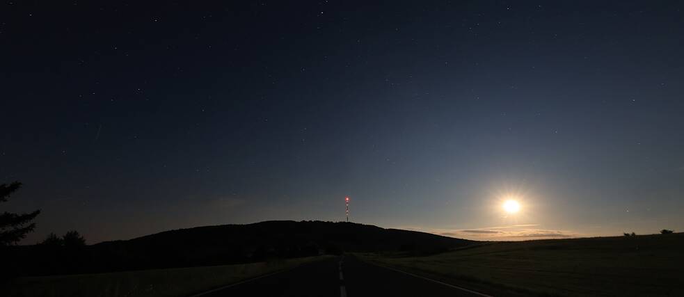 When the moon is shining, its silvery light lies like a veil over the nighttime landscape of hills and meadows.