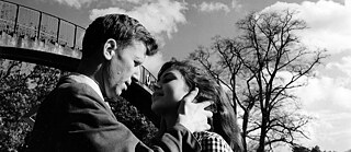 Black and white image of a white man and a white woman looking into each other's eyes