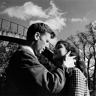 Black and white image of a white man and a white woman looking into each other's eyes
