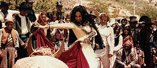 A coloured image of a Spanish dancer in the street surrounded by a group of spectators