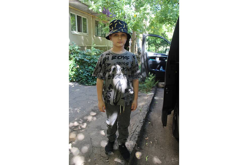 Osmiletý Kyrylo v den evakuace před svým domem ve Slovjansku