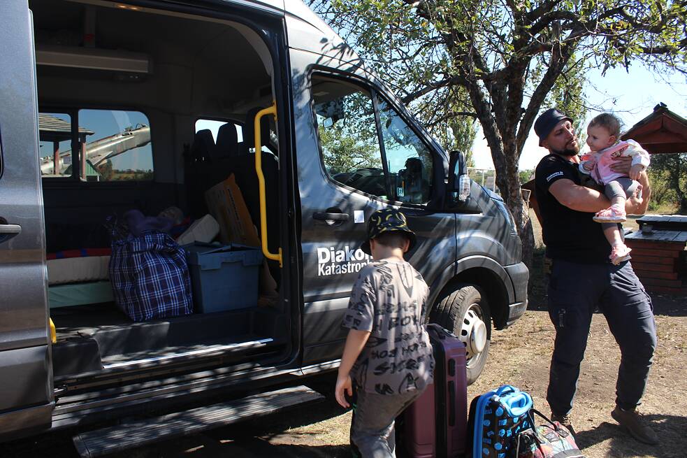 Roman Buhajov s dětmi Kyrylem a Innou při předání jinému evakuačnímu týmu