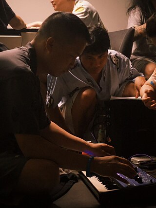 Die Gui of KHONGT HSET and Haoduo Tang of Kindergarten without Walls playing music together 