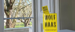 Yellow book by Wolf Haas in front of the window at Goethe-Institut
