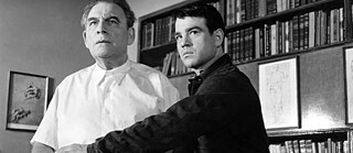 A a younger white man on the right grabs and  older white man in a white doctor's gown by his arm to prevent him from doing something. 