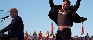 Photo of Elon Musk in a strange jumping gesture alongside Donald Trump. Key image for the film 'Elon Musk Unveiled' a documentary film at Antenna Festival