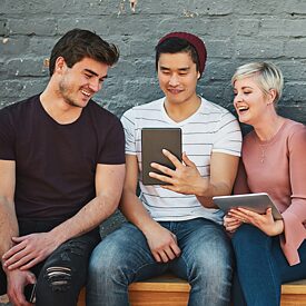 Sitzende Menschengruppe mit mobilen Endgeräten