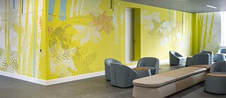 Bright mural on hospital space with seating area