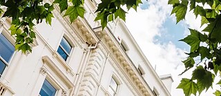 Photo of the building outside, made from under a tree