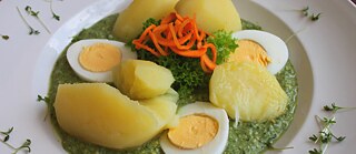 Potatoes and egg with green sauce