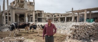 A man in the midst of ruins and rubble