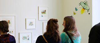 Visitors are looking at the drawings by Axel Scheffler in the exhibition