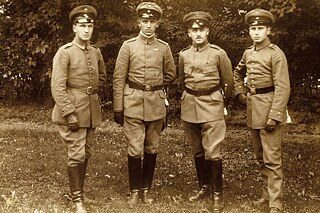 Four young men in Uniform in the 1920s standing on a field