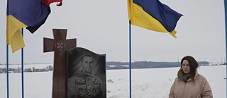 A person standing at a grave