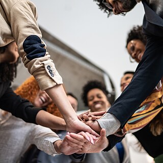 Several people are holding hands.
