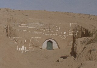 Artwork by Younès Ben Slimane: Desert hillside with an arched doorway cut into the earth, overlaid with delicate white line drawings suggesting underground rooms or ancient structures.