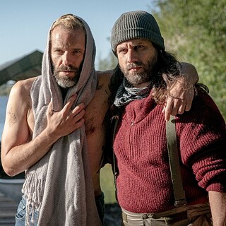Two men hugging each other