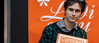 A man holding up a certificate