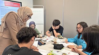 Nadhirah, our German teacher at Goethe-Institut Malaysia guiding students at the classroom table.