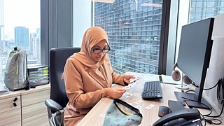 Nadhirah, our German teacher at Goethe-Institut Malaysia working at the office desk in the Teachers Room.