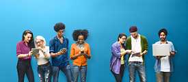 4 young people are looking at their mobile devices against a blue backdrop