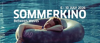 Promotional banner for “Sommerkino – Between Waves” (July 6–10, 2026): A person lies relaxed on a round dark inner tube floating on blue water, likely a pool or lake. Large white overlay text shows the title and dates.