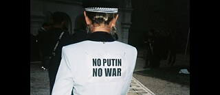 A woman wearing a jacket saying "No Putin, No War"