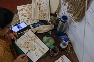 Krishnapriya drawing cultivation scenes with ink extracted from seaweed 