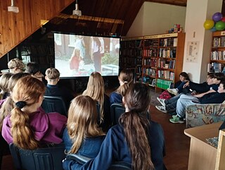 children watching a film in a library