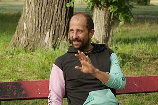 An interviewee on a park bench