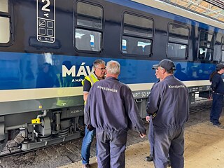 People or engineers in front of a train
