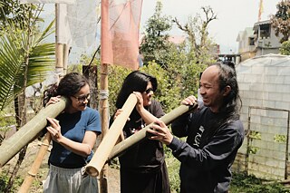 Artist Lalringhetti Sangsiama and collaborators working with bamboo at Echo Stream in Gangtok, Sikkim.