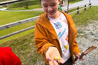 Jugendliche zeigen S'mores in die Kamera.
