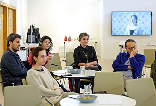 Participants listening to a discussion in an event space.