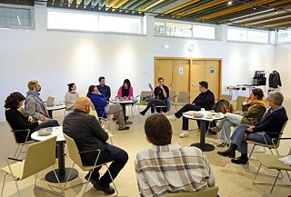 Participants seated in a circle during a discussion event.